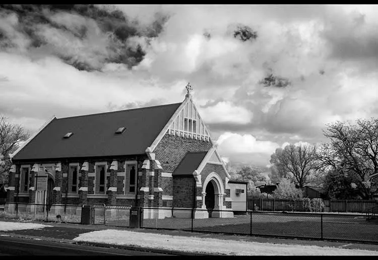 Black and white infrared landscape image looking at a church.